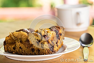 Side view piece of apple pie in a white dish and a cup of coffee, metal spoon Stock Photo