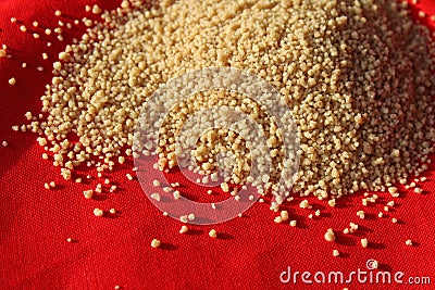 Dried Coucous Pile, against orange background. Stock Photo