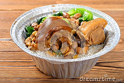 Side view pork knuckle with rice as a take out fast food on wood table Stock Photo