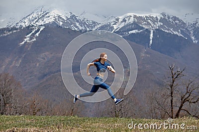 Side View Portrait Of Athlete Redhead Lady Jumping High During Training In Nature, Sportswoman Stock Photo