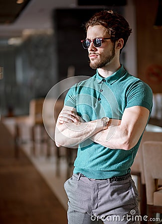 Side view portrait of bodyguard with crossed arms at the cafe. Stock Photo