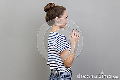 Side view of cunning woman clasping hands and smirking mysteriously, scheming cheats, evil prank. Stock Photo