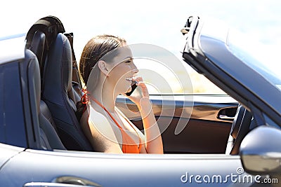 Profile of a car driver calling on phone on vacation Stock Photo