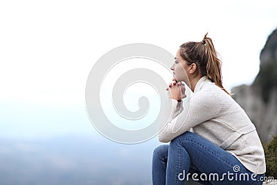 Happy woman contemplating views in the mountain Stock Photo