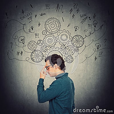 Side view portrait of pensive businessman, keeps index finger to forehead, thinking of solutions to solve the task. Pondering man Stock Photo