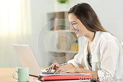 Student e-learning online at home with a laptop Stock Photo