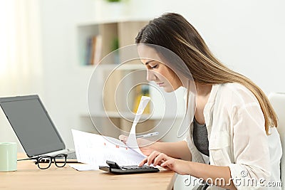 Woman calculating expenses at home Stock Photo