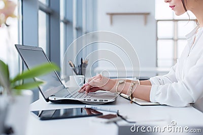 Side view portrait of woman working in home-office as teleworker, typing and surfing internet, having work day. Stock Photo