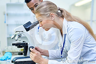 Female Scientist Using Microscope Stock Photo