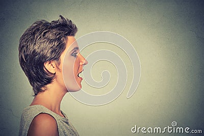 Side view profile woman talking with sound coming out of her open mouth Stock Photo