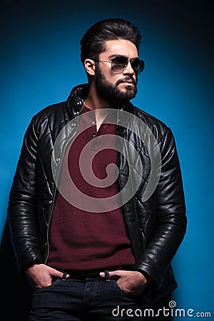 Side view profile of a young bearded fashion man in leather jack Stock Photo