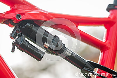 Side view of a rear shock of a modern mountain bicycle attachment point on the rear subframe. Air shock on a bike Stock Photo