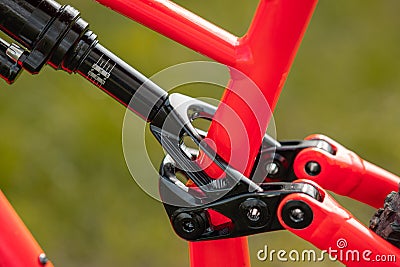 side view of a rear shock of a modern mountain bicycle attachment point on the rear subframe. Air shock on a bike Stock Photo