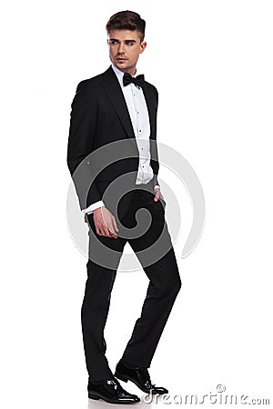 Side view of relaxed businessman in tuxedo looking behind Stock Photo