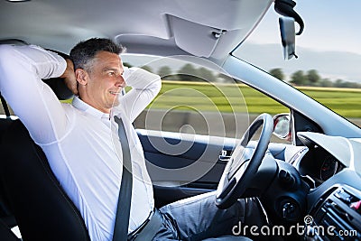 Relaxed Man Sitting In Self Driving Car Stock Photo