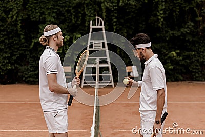 side view of retro styled tennis players starting game Stock Photo