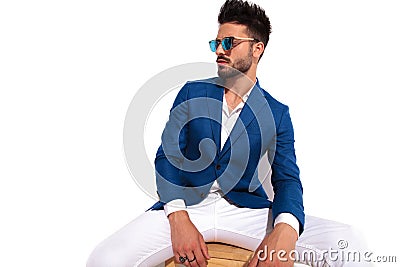 Side view of seated elegant man resting on chair Stock Photo