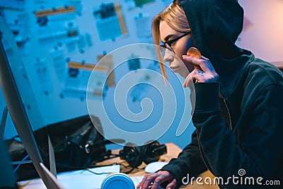 side view of serious young female hacker Editorial Stock Photo