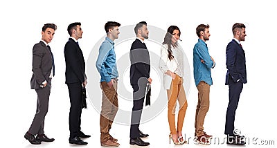 Side view of seven different people standing in line Stock Photo