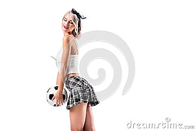 side view of sexy woman in plaid schoolgirl skirt with football ball Stock Photo