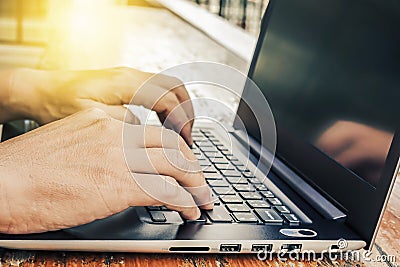 Side view shot of working at cafe with laptop man writing a blog. male hands on the keyboard Stock Photo