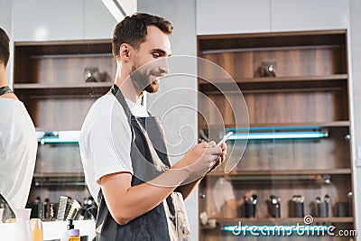 Side view of smiling hairdresser chatting Stock Photo