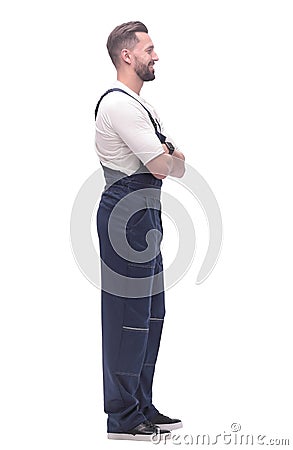 side view. smiling man in overalls looking forward to copy space Stock Photo