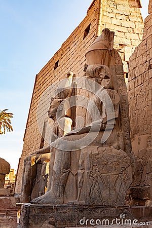 Side view statue of Pharaoh Ramses II at the entrance to the famous Luxor Temple complex Stock Photo