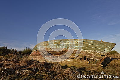 Side view of the stern of a Fishing boat wreck on the Grassy banks of a small Estuary at St Cyrus Stock Photo