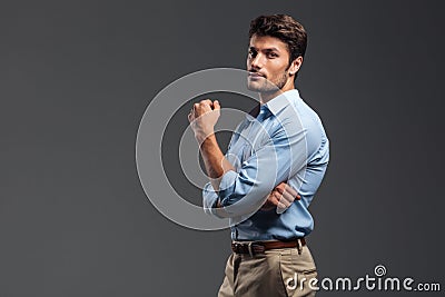 Side view of a successful handsome man with arms folded Stock Photo
