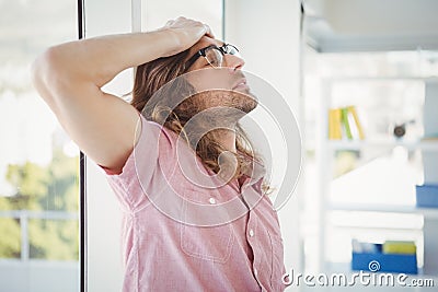 Side view of tired hipster with hand on head Stock Photo