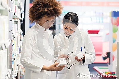 Side view of two dedicated pharmacists looking for the best medicine Stock Photo