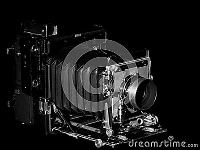 Side View of a Vintage Speed Graphic Bellows Press Camera on a Black Background Editorial Stock Photo