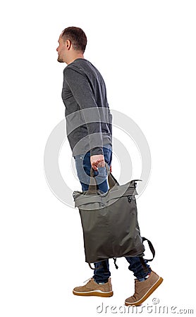 Side view of walking man with green bag. backside view of person Stock Photo