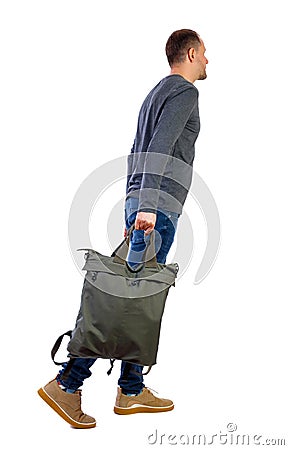 Side view of walking man with green bag. backside view of person Stock Photo