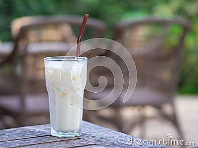 Side view of white chocolate cold in the glass on wooden table Stock Photo