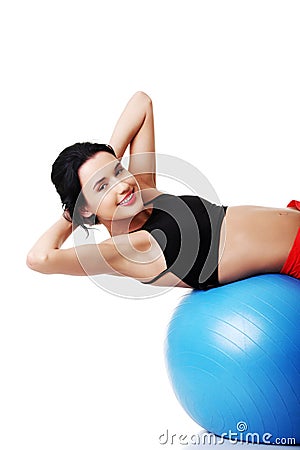 Side view of a woman exercising on fitness ball Stock Photo