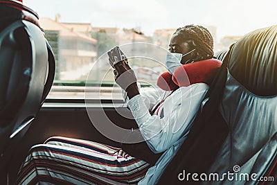 African girl in mask in regular bus Stock Photo