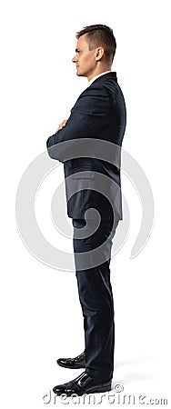 Side view of young businessman with his arms folded looking staight confidently isolated on white background Stock Photo