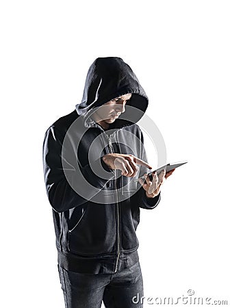 Side view of young hacker using tablet Stock Photo
