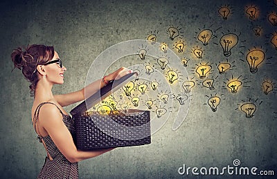 Side view of a woman with box full of brilliant ideas being creative Stock Photo