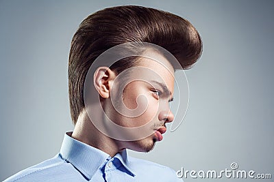 Side view of young man with retro classic pompadour hairstyle. Stock Photo