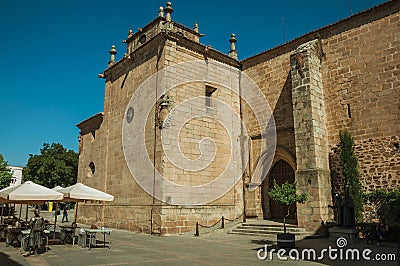 Side wall of church with wooden door at Caceres Editorial Stock Photo
