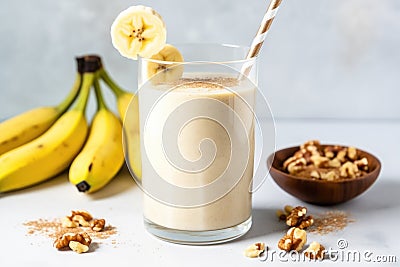 a sidebar view of a walnut banana smoothie with a metal spoon inside Stock Photo
