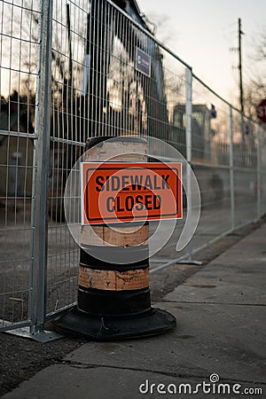 Sidewalk closed orange sign on traffic cone Stock Photo