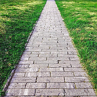 Sidewalk. Straight path of granite gray cobblestone Stock Photo