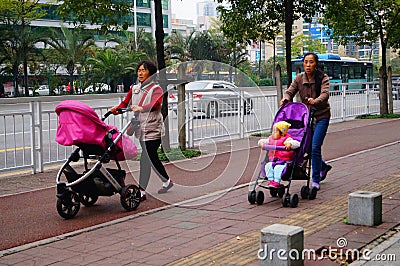 Sidewalk, women pushing baby carriages Editorial Stock Photo