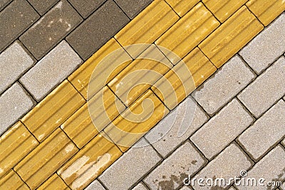 Sidewalk with yellow tactile paving Stock Photo