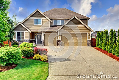 Siding house with stone trim and tile roof Stock Photo