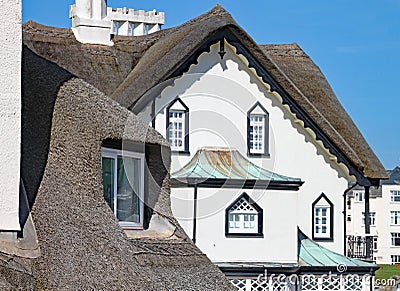 SIDMOUTH, DEVON - APRIL 1ST 2012: The beautiful old thatched residence stands on the Sidmouth coast on a sunny day Editorial Stock Photo